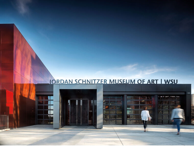 Front of the Jordan Schnitzer Museum of Art WSU with two people walking in