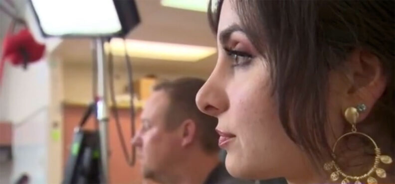 Close-up of a woman in a TV studio being interviewed
