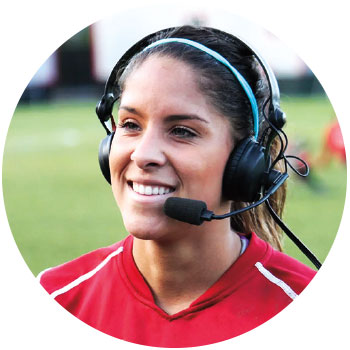 WSU soccer player Micaela Castain wearing a headset, smiling and answering questions