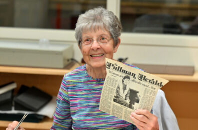 Former AFW president Sue Durrant holds up an archival newspaper about WA state’s Equal Rights Amendment