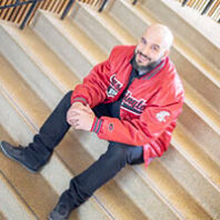 Johnny Lupinacci sits on stairs