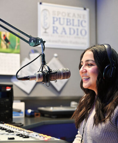 Monica Carrillo-Casas speaks into a microphone at Spokane Public Radio