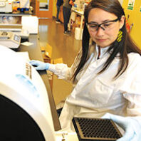 Scientist examines results on a machine