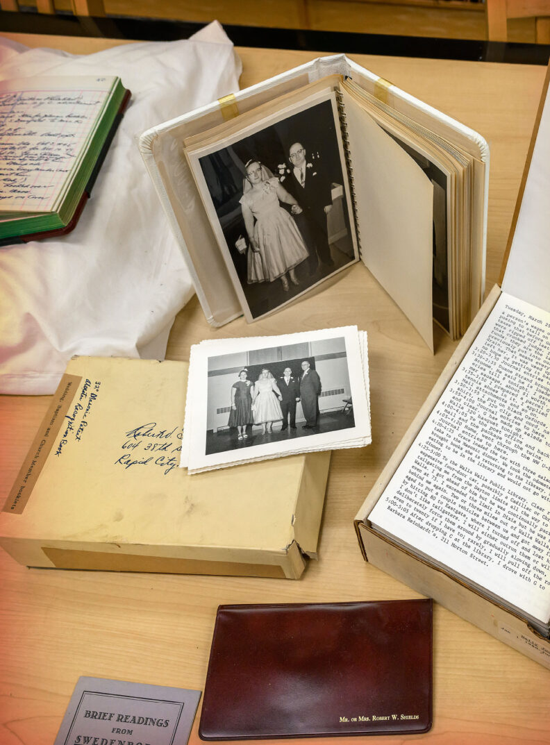 old photos, letters and small boxes arranged on a desktop