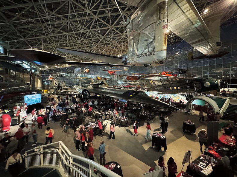 A crowd of people look at aircraft in the Museum of Flight near Seattle