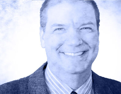 photoillustration of a middle-aged man, smiling, in a suit and striped shirt