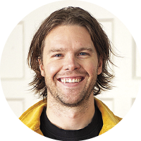 headshot of a smiling young man with light beard