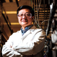 Engineer Yong Wang in safety glasses and lab coat in a lab