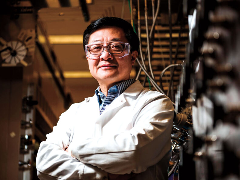 Engineer Yong Wang in safety glasses and lab coat in a lab