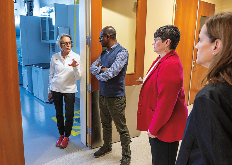 WSU President Elizabeth Cantwell talks with faculty and staff in a lab building
