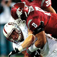 A WSU football player tackles a Stanford football player