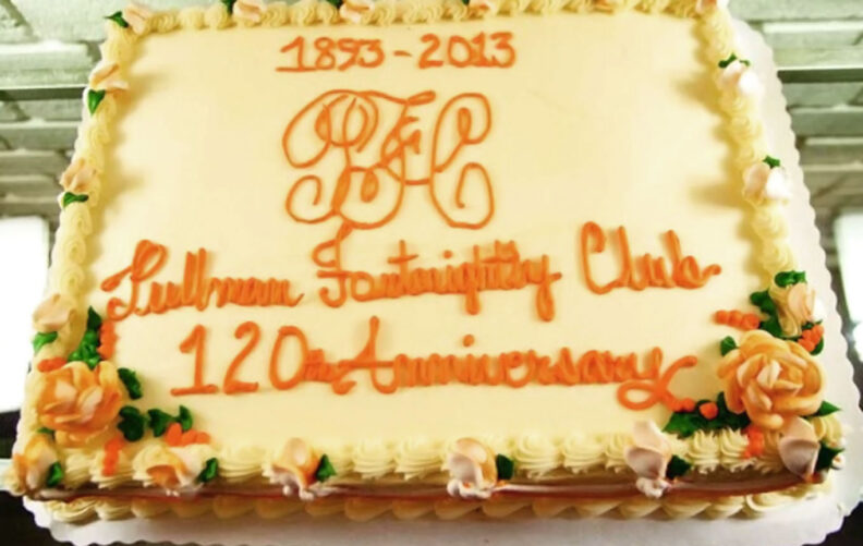 Rectangular cake with yellow frosting and orange writing that reads 1893-2013 Pullman Fortnightly Club 120th Anniversary