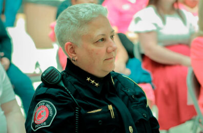 WSU police chief Dawn Daniels in her uniform sits in a crowd at her swearing in.