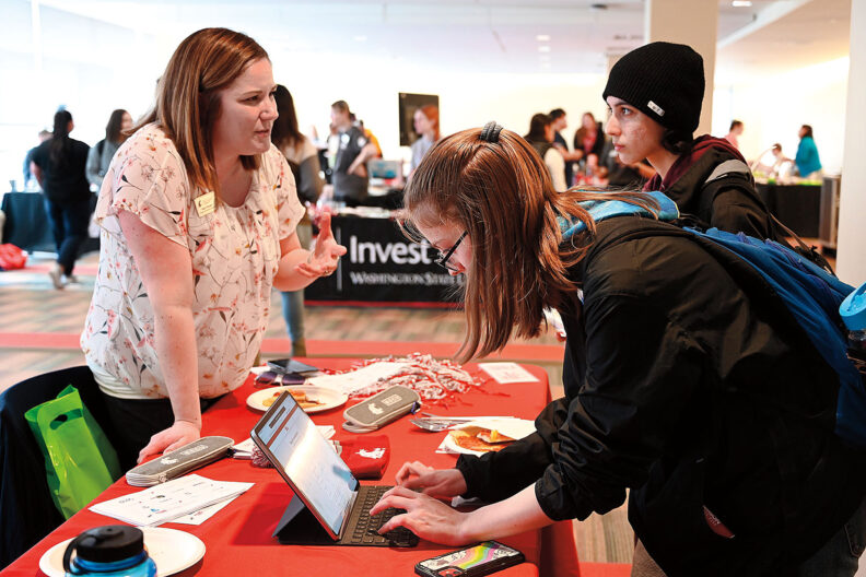 Maja Gillespie talks to two students