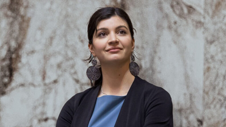 Sharlett Mena profile in blue shirt and dark blazer