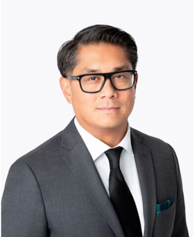 Ben Santos in glasses and a gray suit
