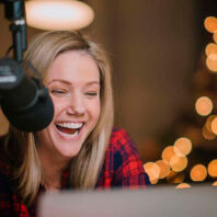 Jaymee Sire laughs in a recording booth