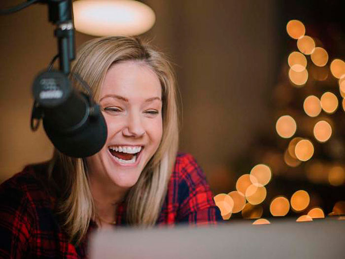 Jaymee Sire laughs in a recording booth
