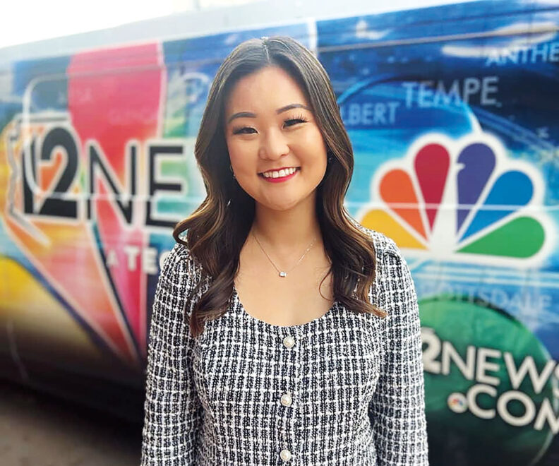 Stella Sun smiling in dress in front of NBC news truck