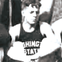 Black-and-white photo of a track athlete wearing a sleeveless jersey with visible text “Washington State,” seated or crouched near a track setting.