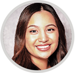 Circular headshot of a woman with long hair, framed by a light gray border against a neutral background.