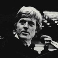 Small cropped thumbnail of a close-up photograph showing an older adult against a dark background.