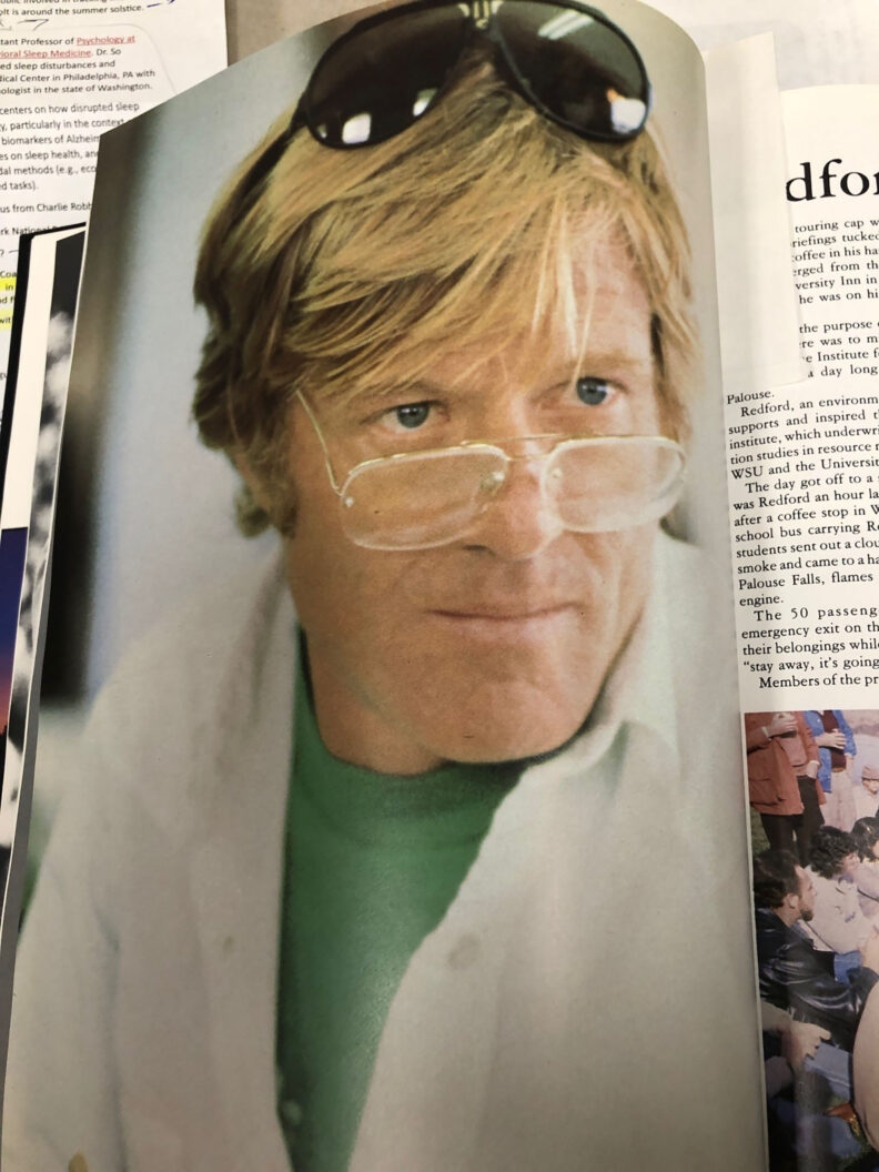 page from a book showing a middle-aged man in white collared short with green t-shirt, wearing glasses