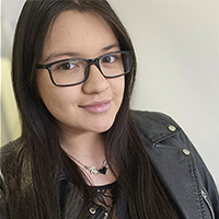 Headshot of Olivia Soliz with glasses and coat