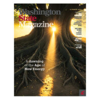 Cover of Washington State Magazine, Summer 2026. Sunlight streams through the roots of a large tree, illuminating a forest floor. Headline reads ‘A dawning of the Age of New Energy,’ with cover lines about nuclear operators, local communities, solar power for schools, hydrogen on the farm, and WSU Cougar running legends.