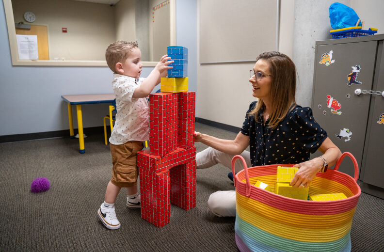 Child plays with blocks in the ASD Clinic