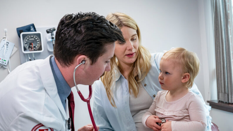 MD Student checking toddlers heart beat