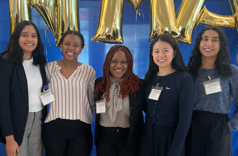 5 MD students at a poster presentation