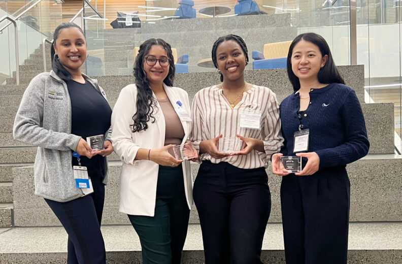 Group of 4 MD students holding awards