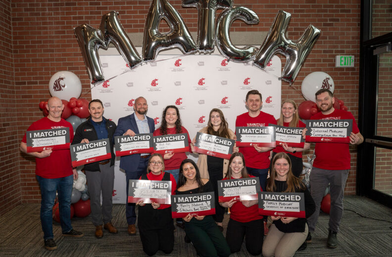 Group of MD students holding match day signs.