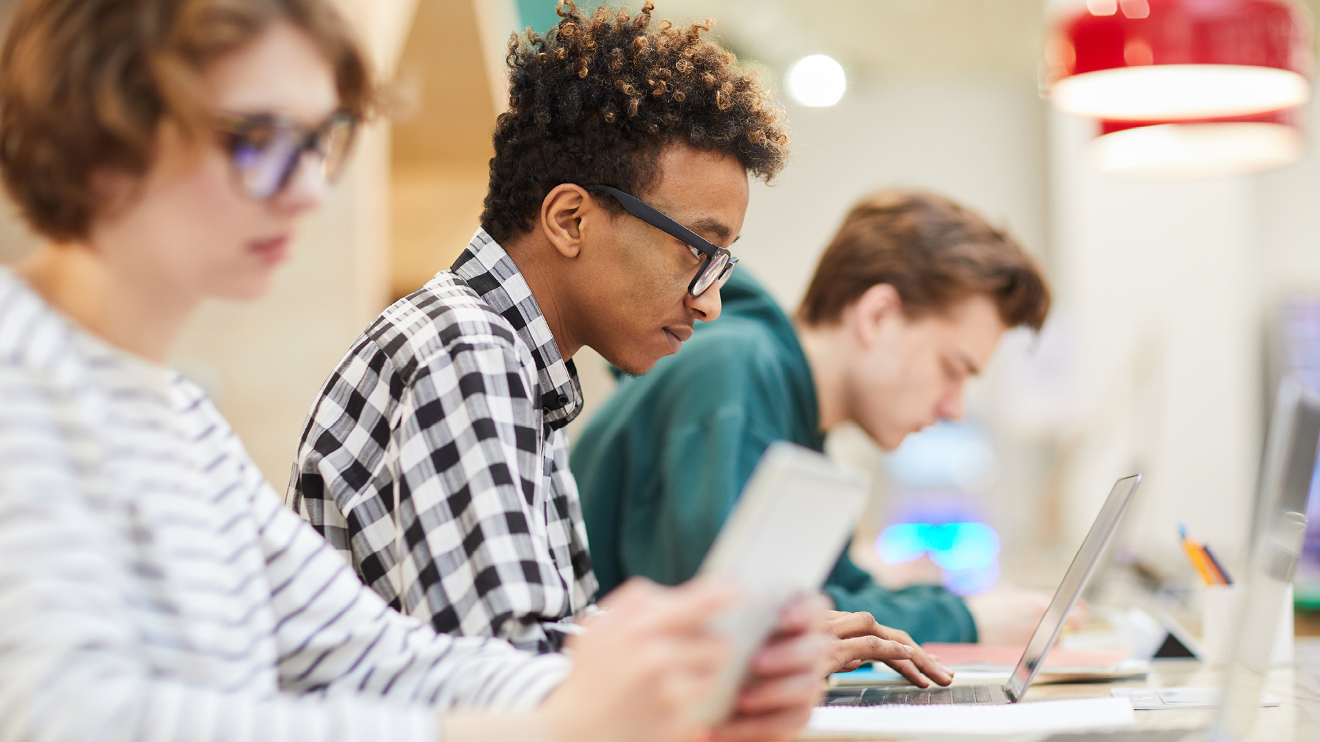 3 students in a computer lab.