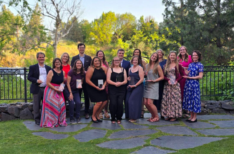 Group of Award winners holding their awards outside in Spokane, WA.