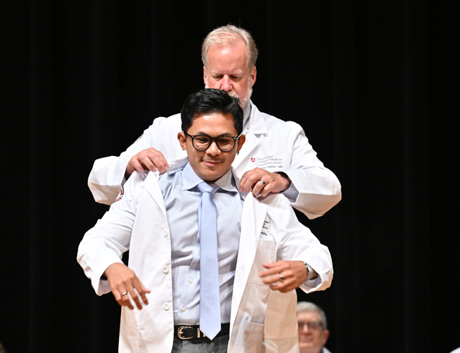 MD Student getting their white coat on.