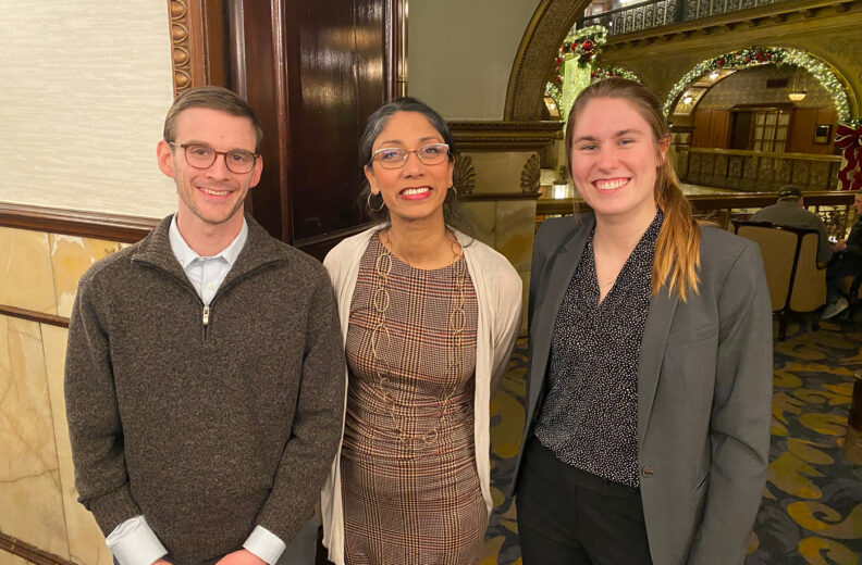 Three people smiling.