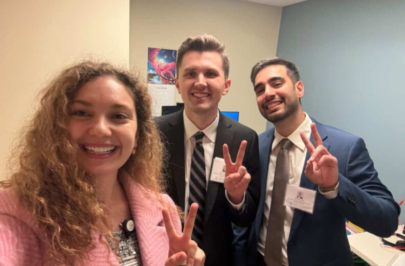 Three people posing and smiling in a selfie.