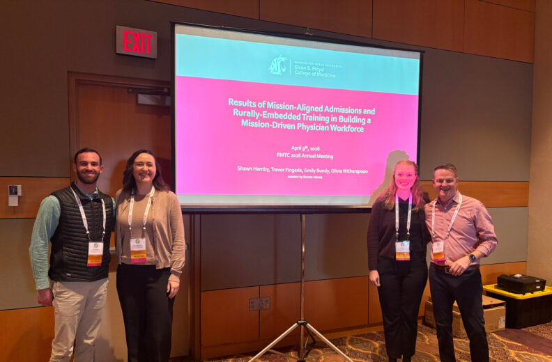 Four presenters stand beside a projection screen displaying a Washington State University Elson S. Floyd College of Medicine presentation at the RMTC Annual Meeting.