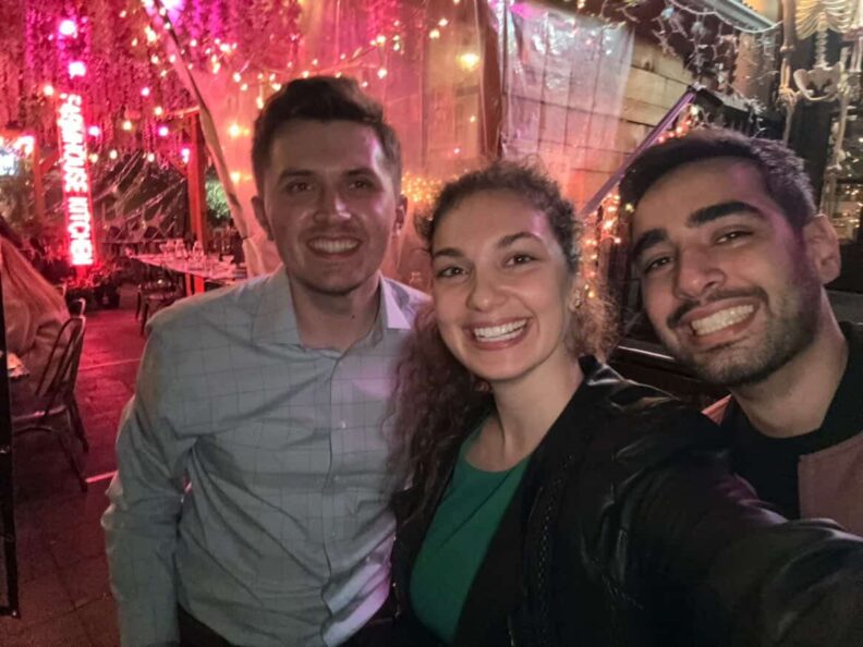 Three people smiling for a selfie.