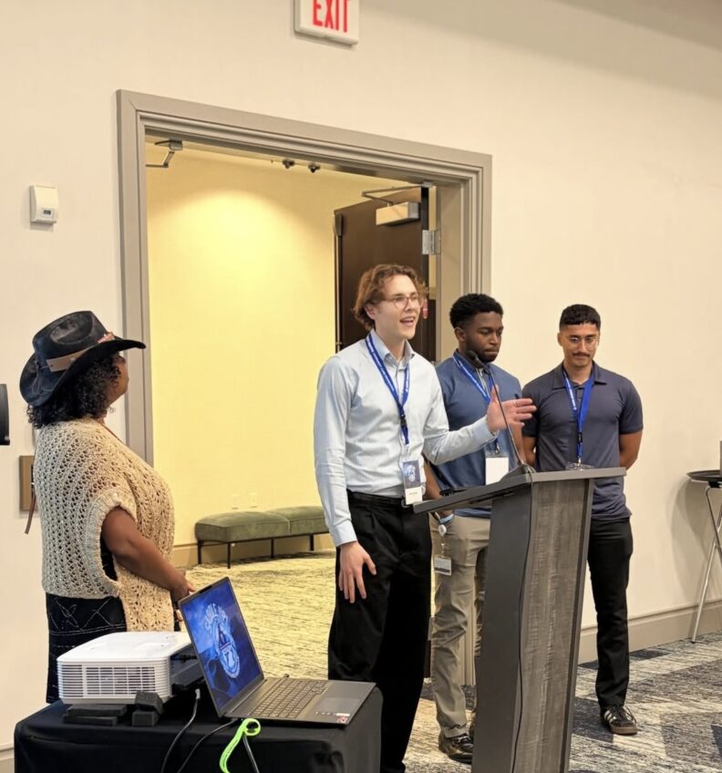 A speaker at a podium speaking. 