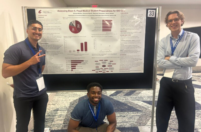 Three presenters pose with a research poster at an academic conference.
