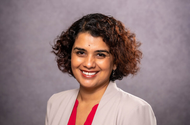 A professional headshot of a women smiling.