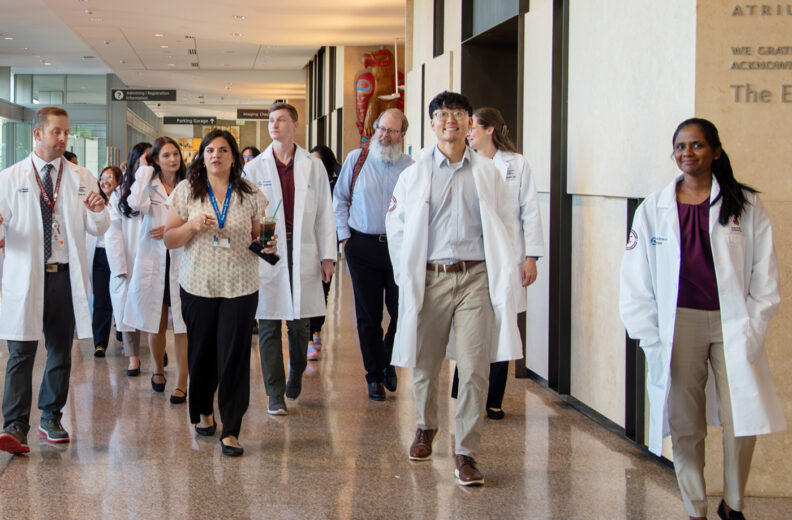 The new internal medicine residents walking through the hallway getting a tour of the hospital in Everett, WA.
