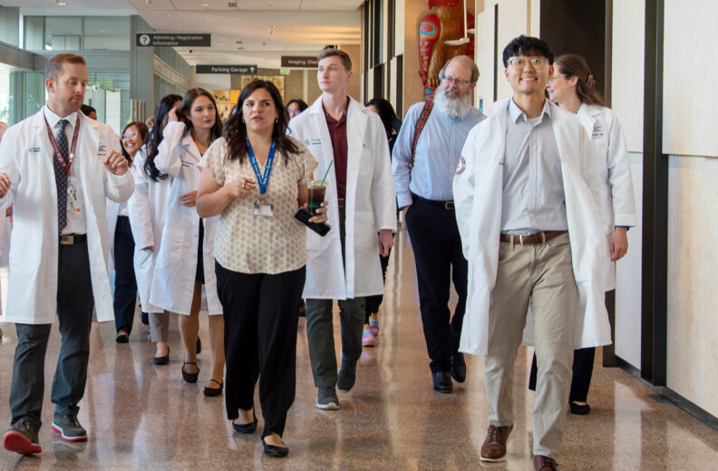 The new internal medicine residents walking through the hallway getting a tour of the hospital in Everett, WA.