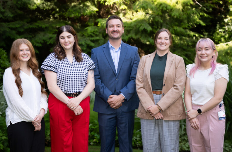 Five new Pediatric residents smiling outside in Spokane, WA.
