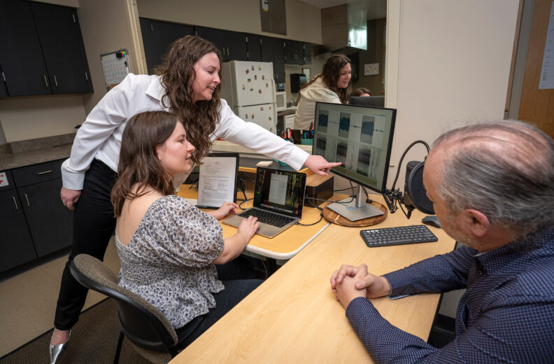 Researchers setting up a speech test.
