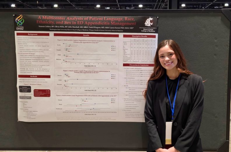 A person standing in front of their research poster.