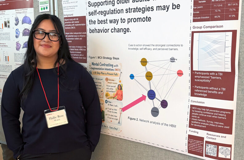 Hallie Walsh next to her poster at the Showcase for Undergraduate Research and Creative Activities.